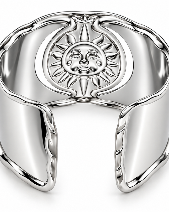 A polished silver cuff bracelet featuring a raised sun and crescent moon design in the center, shown on a clean white background.