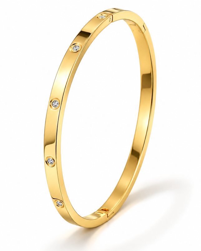 A polished yellow gold bangle bracelet with evenly spaced small round clear stones, shown on a clean white background.